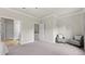 Spacious bedroom with neutral decor, featuring large windows and access to other rooms at 1914 Forte Ln, Alpharetta, GA 30009