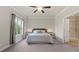 Bright bedroom with a window, ceiling fan and ensuite bathroom featuring a glass door at 1914 Forte Ln, Alpharetta, GA 30009