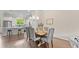 Elegant dining area with hardwood floors, stylish chairs, and modern lighting fixtures at 1914 Forte Ln, Alpharetta, GA 30009