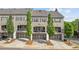 Townhome exterior showcasing a row of units with attached garages and tidy landscaping, creating curb appeal at 1914 Forte Ln, Alpharetta, GA 30009