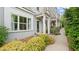 Charming townhome exterior showing sidewalk, manicured bushes and a quaint front entrance at 1914 Forte Ln, Alpharetta, GA 30009