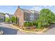 Charming townhome with brick and siding exterior, beautiful landscaping and mature trees at 1914 Forte Ln, Alpharetta, GA 30009