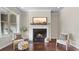 Cozy fireplace with white mantel, dark hearth, and a decorative landscape art piece above at 1914 Forte Ln, Alpharetta, GA 30009