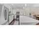 Modern kitchen with stainless steel appliances, white cabinets, subway tile backsplash and large island at 1914 Forte Ln, Alpharetta, GA 30009