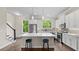 Spacious kitchen with white cabinets, stainless steel appliances, and large center island with seating at 1914 Forte Ln, Alpharetta, GA 30009
