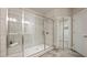 Modern bathroom shower featuring glass enclosure, tiled walls, and sleek fixtures, creating a spa-like ambiance at 1914 Forte Ln, Alpharetta, GA 30009
