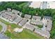 A scenic aerial view of a well-maintained townhome community with lush greenery and ample parking at 2173 Pebble Beach Dr, Lawrenceville, GA 30043
