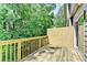 Inviting wooden back deck provides a serene spot to enjoy lush green trees at 2173 Pebble Beach Dr, Lawrenceville, GA 30043