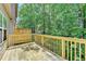 Back deck surrounded by green trees at 2173 Pebble Beach Dr, Lawrenceville, GA 30043
