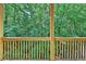 Covered deck shows wooden railings and peaceful wooded surroundings at 2173 Pebble Beach Dr, Lawrenceville, GA 30043