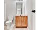 A cozy bathroom featuring a toilet, a vanity with wooden cabinets, and a large mirror at 2173 Pebble Beach Dr, Lawrenceville, GA 30043