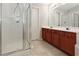 Bathroom featuring a standard shower, double vanity, and linoleum flooring at 2173 Pebble Beach Dr, Lawrenceville, GA 30043