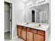 Primary bathroom with double sink vanity, white counters and cabinetry with a glass enclosed shower at 2173 Pebble Beach Dr, Lawrenceville, GA 30043