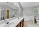 Bathroom with double sink vanity with a separate bathtub and tile floors at 2173 Pebble Beach Dr, Lawrenceville, GA 30043