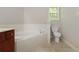 Bathroom featuring a tub and a toilet at 2173 Pebble Beach Dr, Lawrenceville, GA 30043