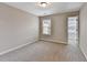 Bright bedroom featuring neutral walls, plush carpeting, and a window providing natural light at 2173 Pebble Beach Dr, Lawrenceville, GA 30043