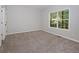 Neutral bedroom with large window allowing natural light and plush carpet at 2173 Pebble Beach Dr, Lawrenceville, GA 30043