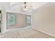 Large main bedroom featuring a tray ceiling with fan and windows that let in natural light at 2173 Pebble Beach Dr, Lawrenceville, GA 30043
