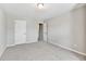 Bright, carpeted bedroom featuring neutral walls and doors to closets or other rooms at 2173 Pebble Beach Dr, Lawrenceville, GA 30043