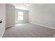 A bedroom featuring carpet, white walls, and a single window at 2173 Pebble Beach Dr, Lawrenceville, GA 30043