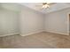 A bedroom featuring neutral carpet, grey walls, and a ceiling fan at 2173 Pebble Beach Dr, Lawrenceville, GA 30043