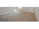 Bright bedroom with neutral carpet, grey walls, and a single window at 2173 Pebble Beach Dr, Lawrenceville, GA 30043