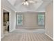 Main bedroom featuring tray ceilings, ceiling fan and two windows which provide plenty of natural light at 2173 Pebble Beach Dr, Lawrenceville, GA 30043