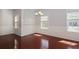 Dining room featuring wainscotting, cherry hardwood floors, and three large windows at 2173 Pebble Beach Dr, Lawrenceville, GA 30043