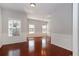 Dining room featuring wainscotting, cherry hardwood floors, and two large windows at 2173 Pebble Beach Dr, Lawrenceville, GA 30043