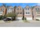 Traditional townhome features brick facade, gray accents, garage and a well-manicured lawn at 2173 Pebble Beach Dr, Lawrenceville, GA 30043