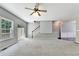 Bright living room with neutral carpet, backyard access, and staircase at 2173 Pebble Beach Dr, Lawrenceville, GA 30043