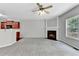 Living room with neutral carpet, fireplace, and view of the kitchen at 2173 Pebble Beach Dr, Lawrenceville, GA 30043