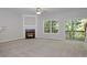 Neutral living room with a fireplace, ceiling fan, large window and sliding door to the deck at 2173 Pebble Beach Dr, Lawrenceville, GA 30043