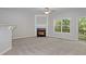 Neutral living room with a fireplace, ceiling fan, large window and sliding door to the deck at 2173 Pebble Beach Dr, Lawrenceville, GA 30043