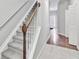 Carpeted staircase with white railings and wood accents at 2173 Pebble Beach Dr, Lawrenceville, GA 30043