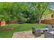 Large, landscaped backyard with a patio, table with chairs and a trampoline at 2713 Stillwater Lake Ln, Marietta, GA 30066
