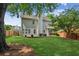 Spacious, green backyard with patio seating under mature shade trees, providing a serene outdoor space at 2713 Stillwater Lake Ln, Marietta, GA 30066