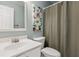 Bathroom with a sink and vanity with a decorative painting on the wall beside a shower curtain at 2713 Stillwater Lake Ln, Marietta, GA 30066