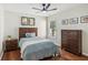 Cozy bedroom featuring a ceiling fan, hardwood floors, and light blue bedding at 2713 Stillwater Lake Ln, Marietta, GA 30066