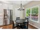 Bright breakfast nook with stainless steel refrigerator, modern lighting fixture, and views of the landscaped yard at 2713 Stillwater Lake Ln, Marietta, GA 30066