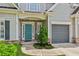 Inviting front entrance with a teal door, brick accents, and a well-maintained lawn, offering great curb appeal at 2713 Stillwater Lake Ln, Marietta, GA 30066
