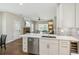 Open concept kitchen with white cabinets, stainless steel appliances, quartz countertops, and a view of the living room at 2713 Stillwater Lake Ln, Marietta, GA 30066
