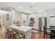 Modern kitchen with white cabinets, stainless steel appliances, quartz countertops, and hardwood floors at 2713 Stillwater Lake Ln, Marietta, GA 30066