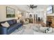 Open concept living room with stone fireplace, ceiling fan, plenty of seating, and views of the kitchen at 2713 Stillwater Lake Ln, Marietta, GA 30066