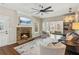Bright and airy living room features a stone fireplace, ceiling fan, and an open layout at 2713 Stillwater Lake Ln, Marietta, GA 30066
