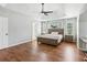 Bright main bedroom with hardwood floors, trey ceiling, modern ceiling fan, and multiple windows at 2713 Stillwater Lake Ln, Marietta, GA 30066