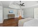 Large main bedroom with trey ceiling, hardwood floors, modern ceiling fan, and a dresser at 2713 Stillwater Lake Ln, Marietta, GA 30066