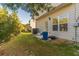 Backyard featuring green grass and the side of the home with a door and windows at 7162 Fringe Flower Dr, Austell, GA 30168
