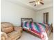 Bright bedroom with a charming armchair, a bed and a ceiling fan providing a relaxing space at 7162 Fringe Flower Dr, Austell, GA 30168
