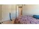 A bedroom with a patterned bedspread and view into another room at 7162 Fringe Flower Dr, Austell, GA 30168